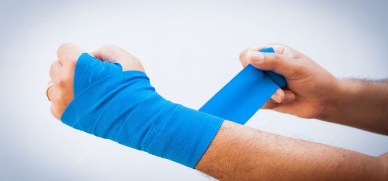 37885992 - close-up of male bandaging his arm