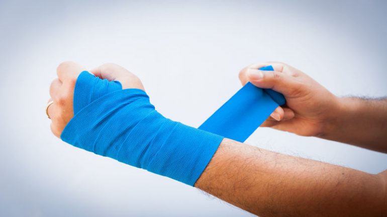 37885992 - close-up of male bandaging his arm